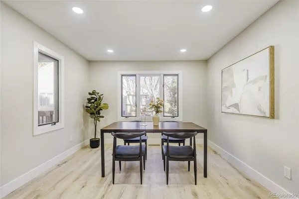 a view of a dining room with furniture and a potted plant