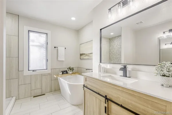 a bathroom with a sink a mirror and a bathtub