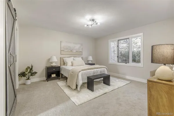 a bedroom with a bed and a potted plant