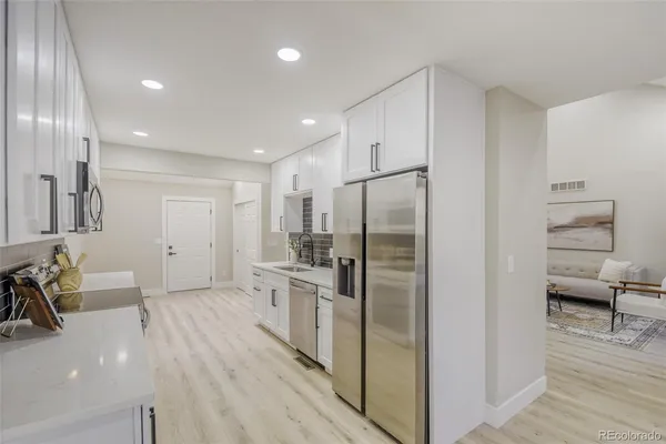 a kitchen with stainless steel appliances a refrigerator and a sink