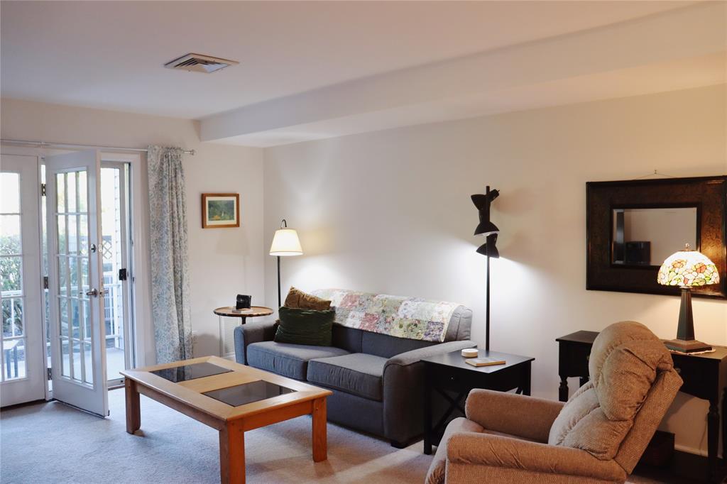 a living room with furniture and a lamp