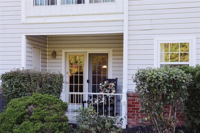 a view of front door of house with potted plants