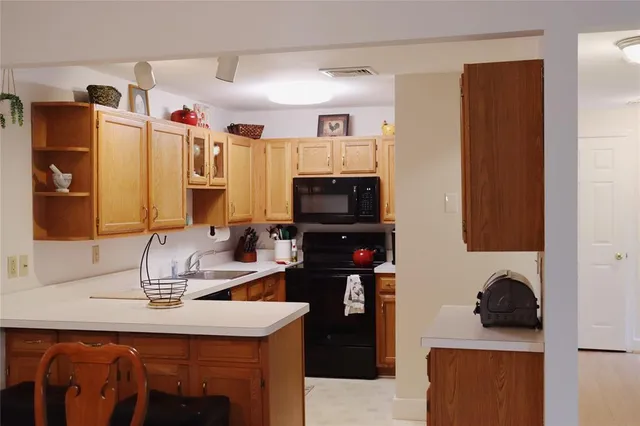 a kitchen with a sink refrigerator and microwave