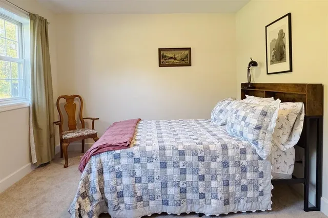 a bedroom with bed and cupboard