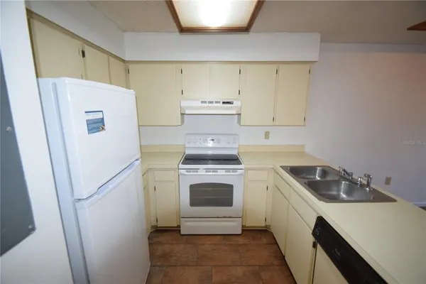 a utility room with sink dryer and washer