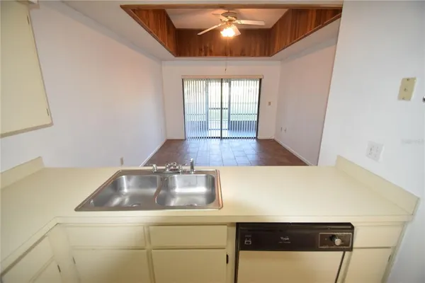 a kitchen with a sink a counter top space and cabinets