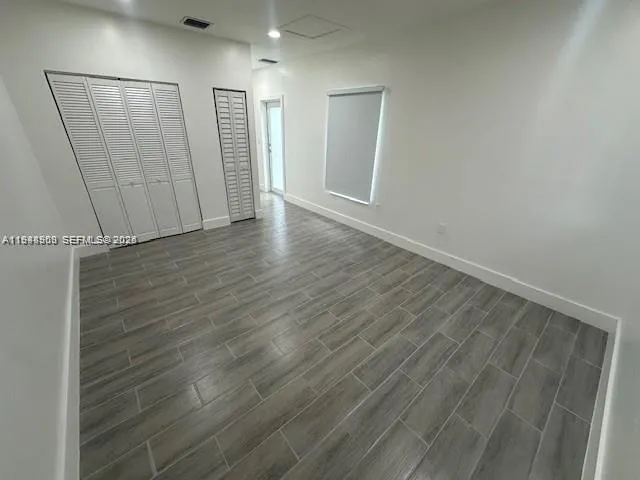 an empty room with wooden floor