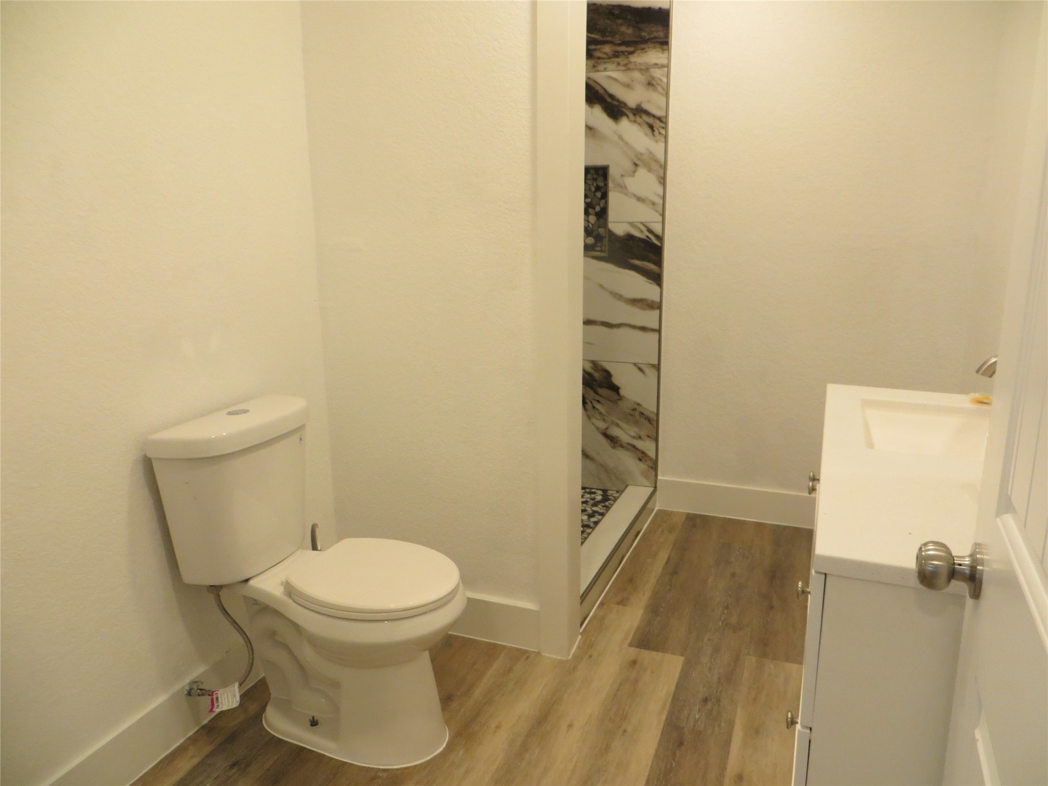 2910 Rose Street Pasadena, TX 77503 - Photo 13 of 18 a white toilet sitting next to a shower curtain