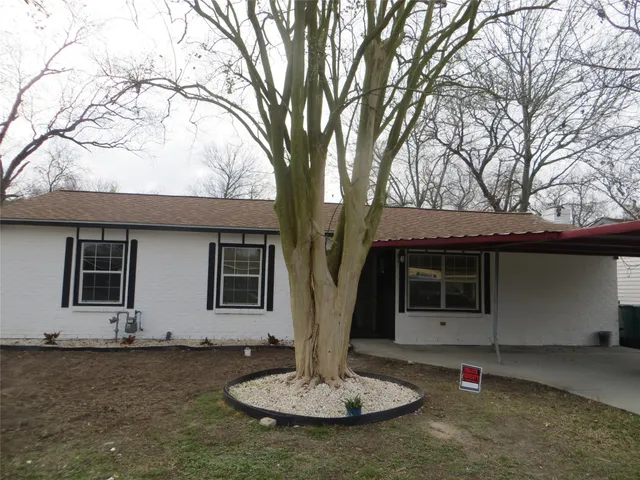 a house with tree in front of it