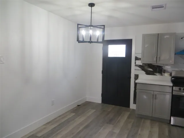 a view of a kitchen with a sink wooden floor and windows