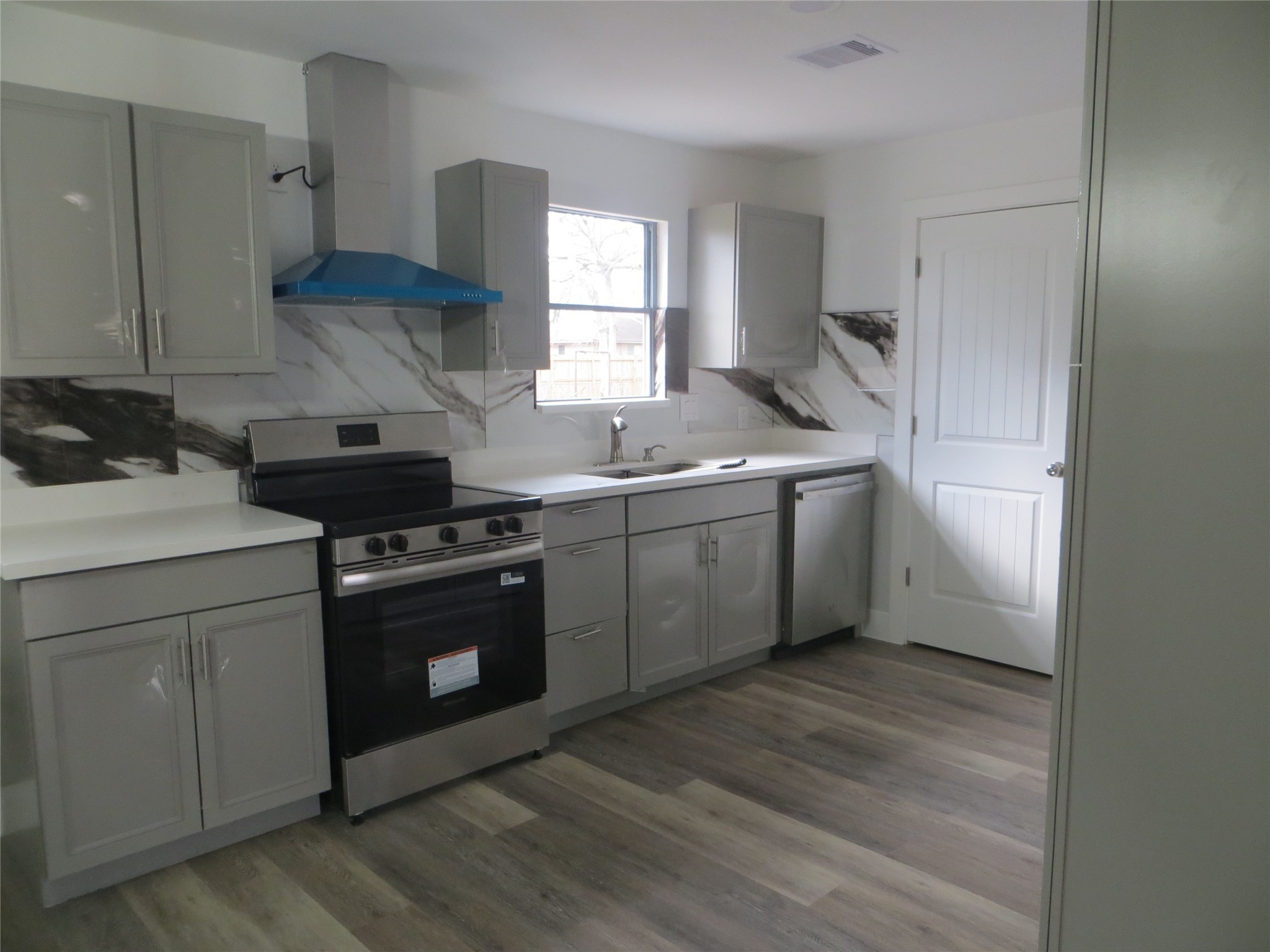 2910 Rose Street Pasadena, TX 77503 - Photo 4 of 18 a kitchen with a stove sink and cabinets