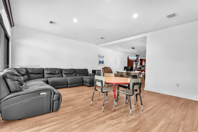 a view of a livingroom with furniture and a flat screen tv