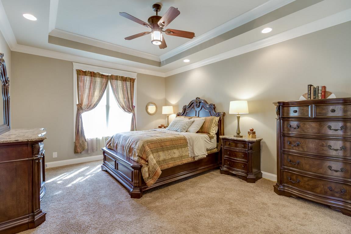 4680 Sango Road Clarksville, TN 37043 - Photo 13 of 29 a spacious bedroom with a bed and a chandelier