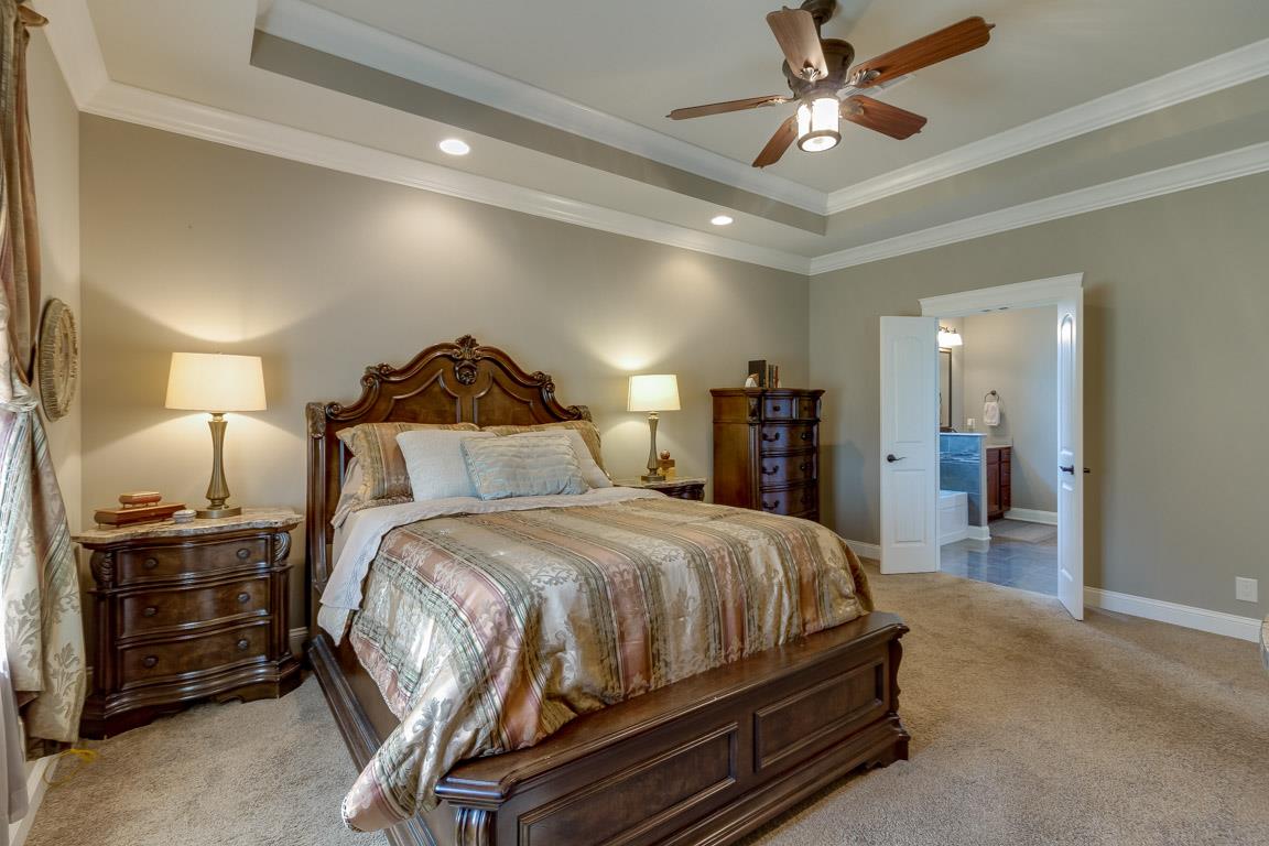 4680 Sango Road Clarksville, TN 37043 - Photo 14 of 29 a spacious bedroom with a bed and a ceiling fan