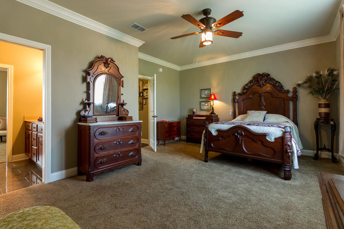 4680 Sango Road Clarksville, TN 37043 - Photo 18 of 29 a bedroom with a bed and a chandelier