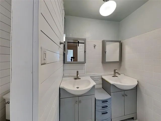 a bathroom with 2 sink and a mirror