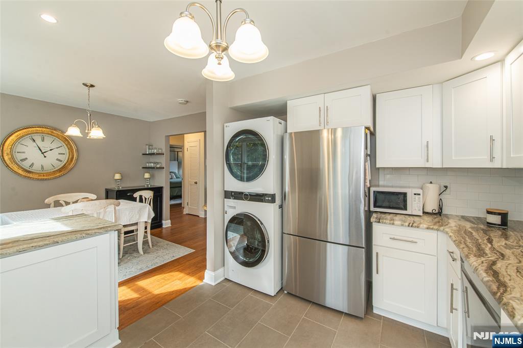 271 Collignon Way, Unit 8B River Vale, NJ 07675 - Photo 12 of 26 a view of a kitchen with a stove top oven and cabinets