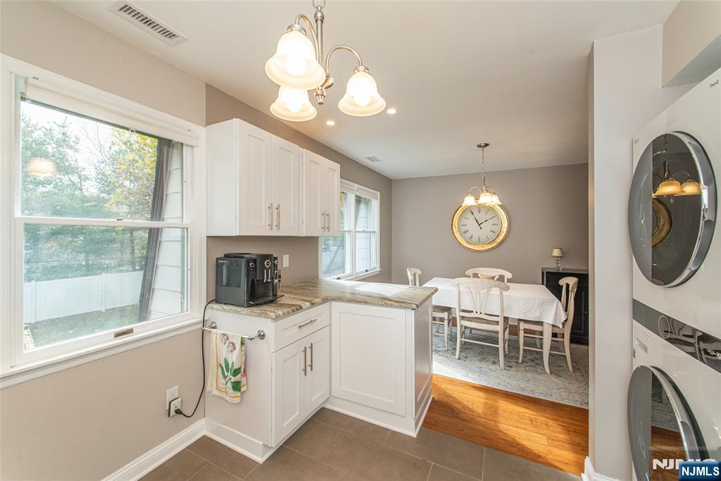 271 Collignon Way, Unit 8B River Vale, NJ 07675 - Photo 13 of 26 a living room with furniture a fireplace and a large window