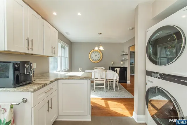 a kitchen with stainless steel appliances granite countertop a sink and a refrigerator