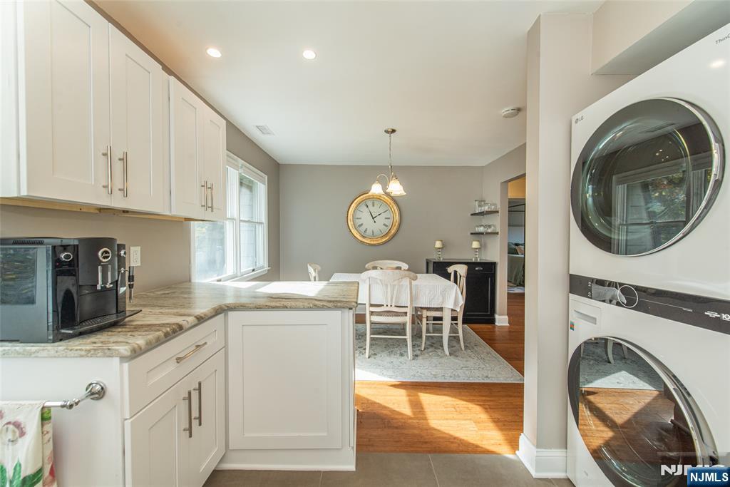 271 Collignon Way, Unit 8B River Vale, NJ 07675 - Photo 14 of 26 a kitchen with stainless steel appliances granite countertop a sink and a refrigerator