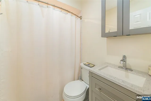 a white toilet sitting next to a bathroom sink