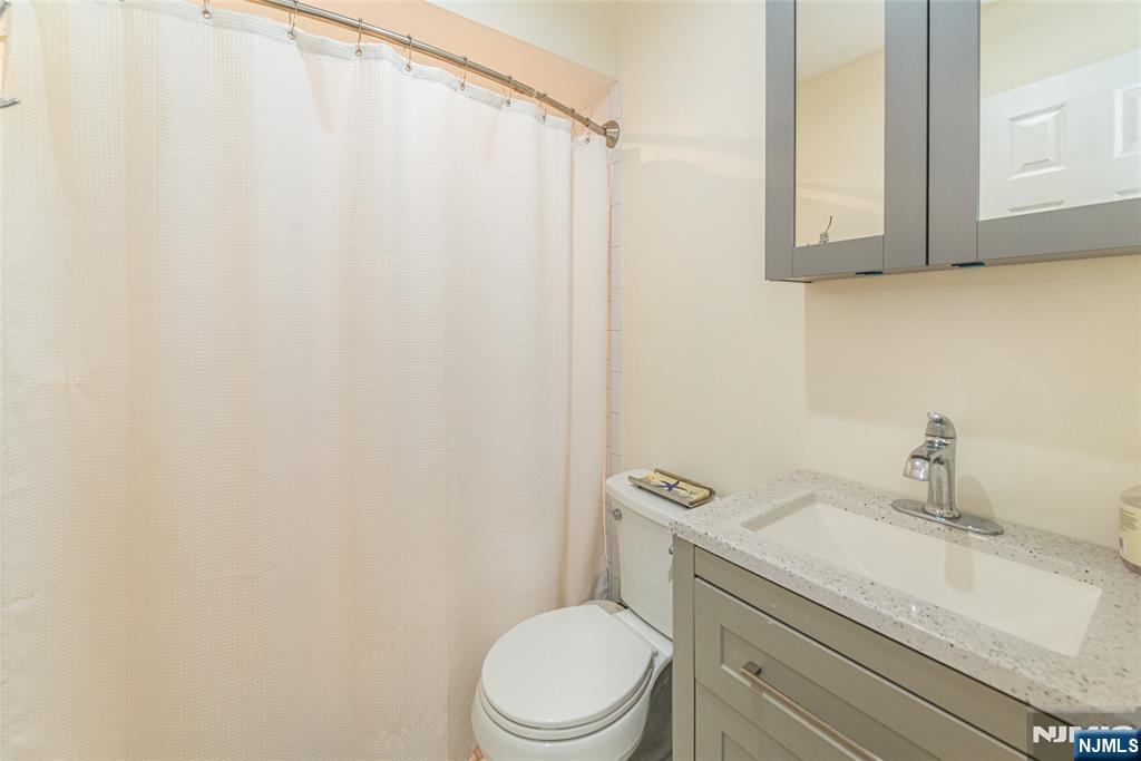 271 Collignon Way, Unit 8B River Vale, NJ 07675 - Photo 15 of 26 a white toilet sitting next to a bathroom sink
