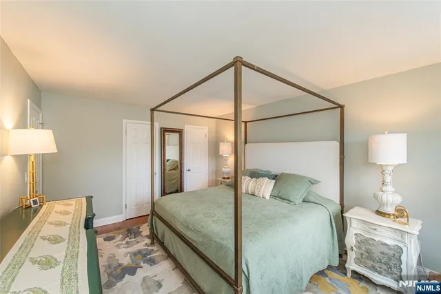 a bedroom with a bed and a lamp