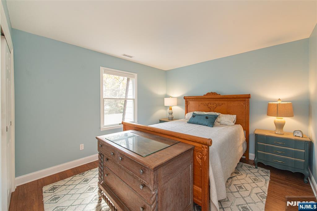 271 Collignon Way, Unit 8B River Vale, NJ 07675 - Photo 20 of 26 a bedroom with a bed and a window