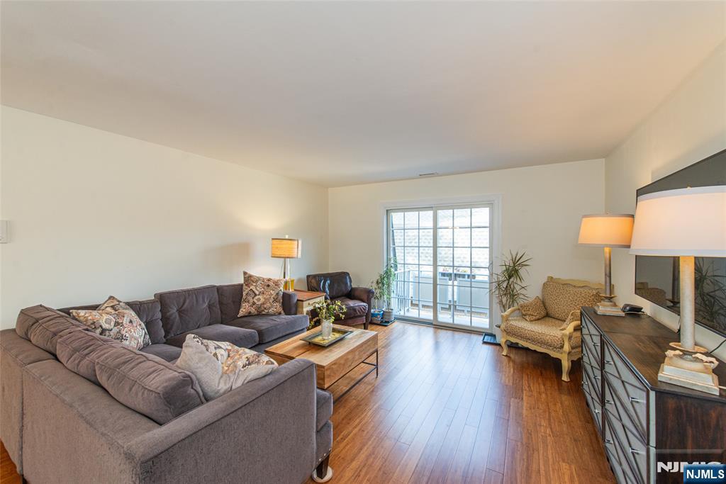 271 Collignon Way, Unit 8B River Vale, NJ 07675 - Photo 2 of 26 a living room with furniture and a wooden floor