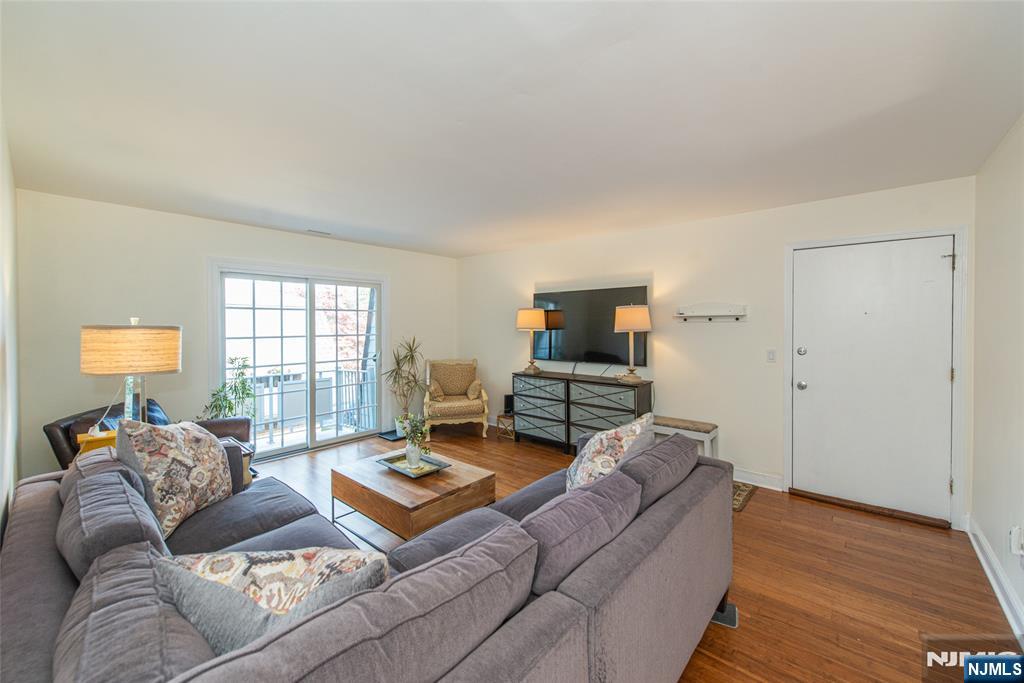 271 Collignon Way, Unit 8B River Vale, NJ 07675 - Photo 4 of 26 a living room with furniture and a flat screen tv