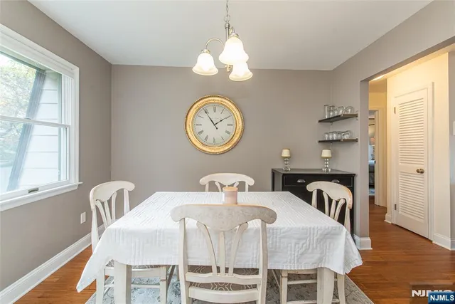 a view of a dining room with furniture and a large window