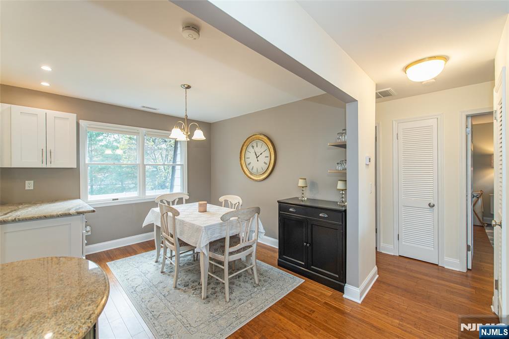 271 Collignon Way, Unit 8B River Vale, NJ 07675 - Photo 8 of 26 a view of a dining room with furniture window and wooden floor