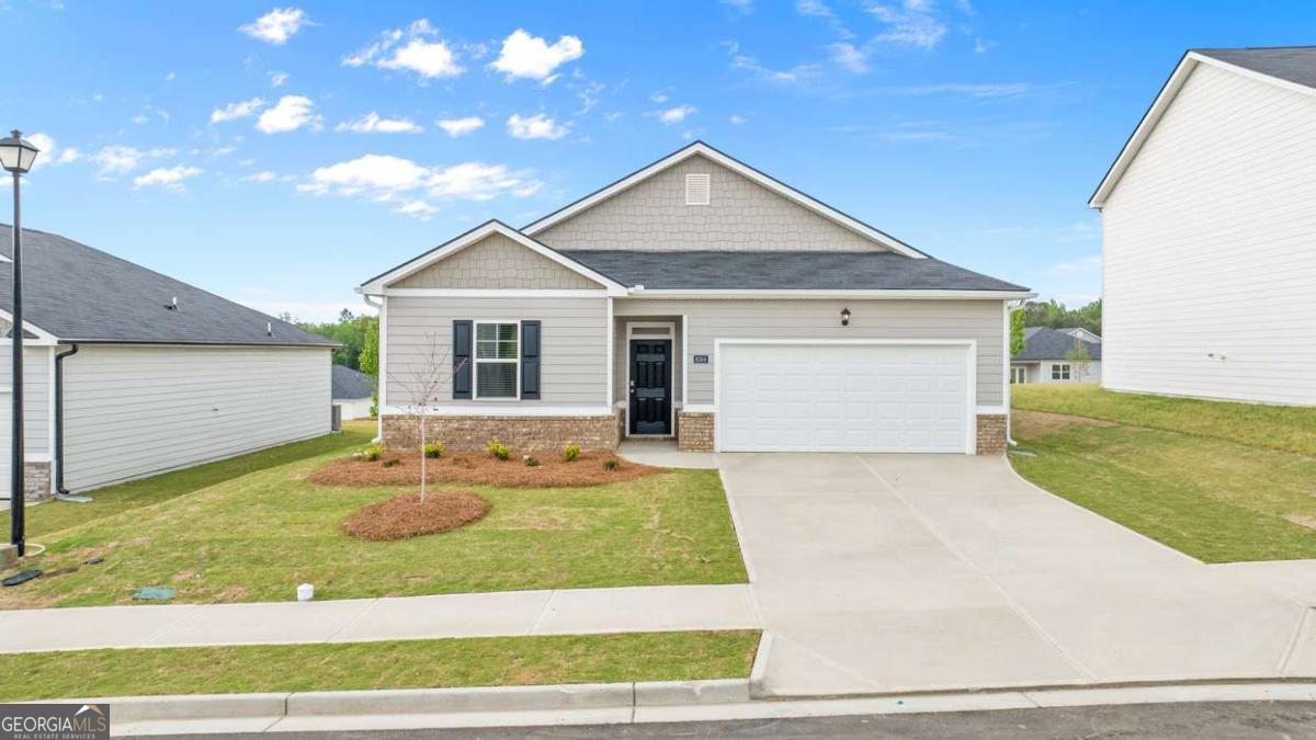 8576 Seabiscuit Road Lithonia, GA 30058 - Photo 1 of 22 a front view of a house with a yard