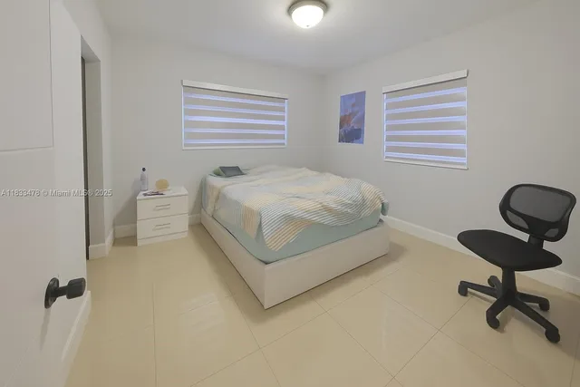 a bedroom with a bed and a chair