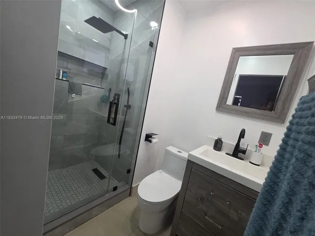 a bathroom with a toilet sink and shower
