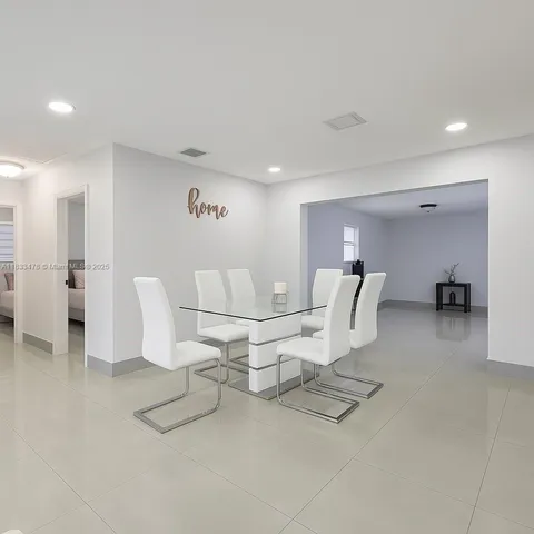 a living room with furniture a table and chairs