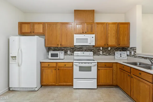 a kitchen with stainless steel appliances a stove sink and refrigerator