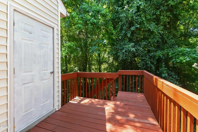 a balcony with wooden floor and outdoor space