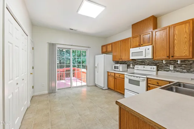 a kitchen with stainless steel appliances a stove sink and cabinets