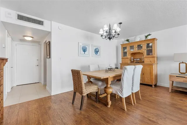 a view of a dining room with furniture wooden floor and a chandelier