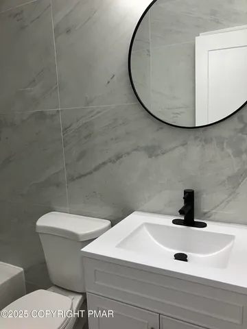 a kitchen with cabinets stainless steel appliances a sink and wooden floor