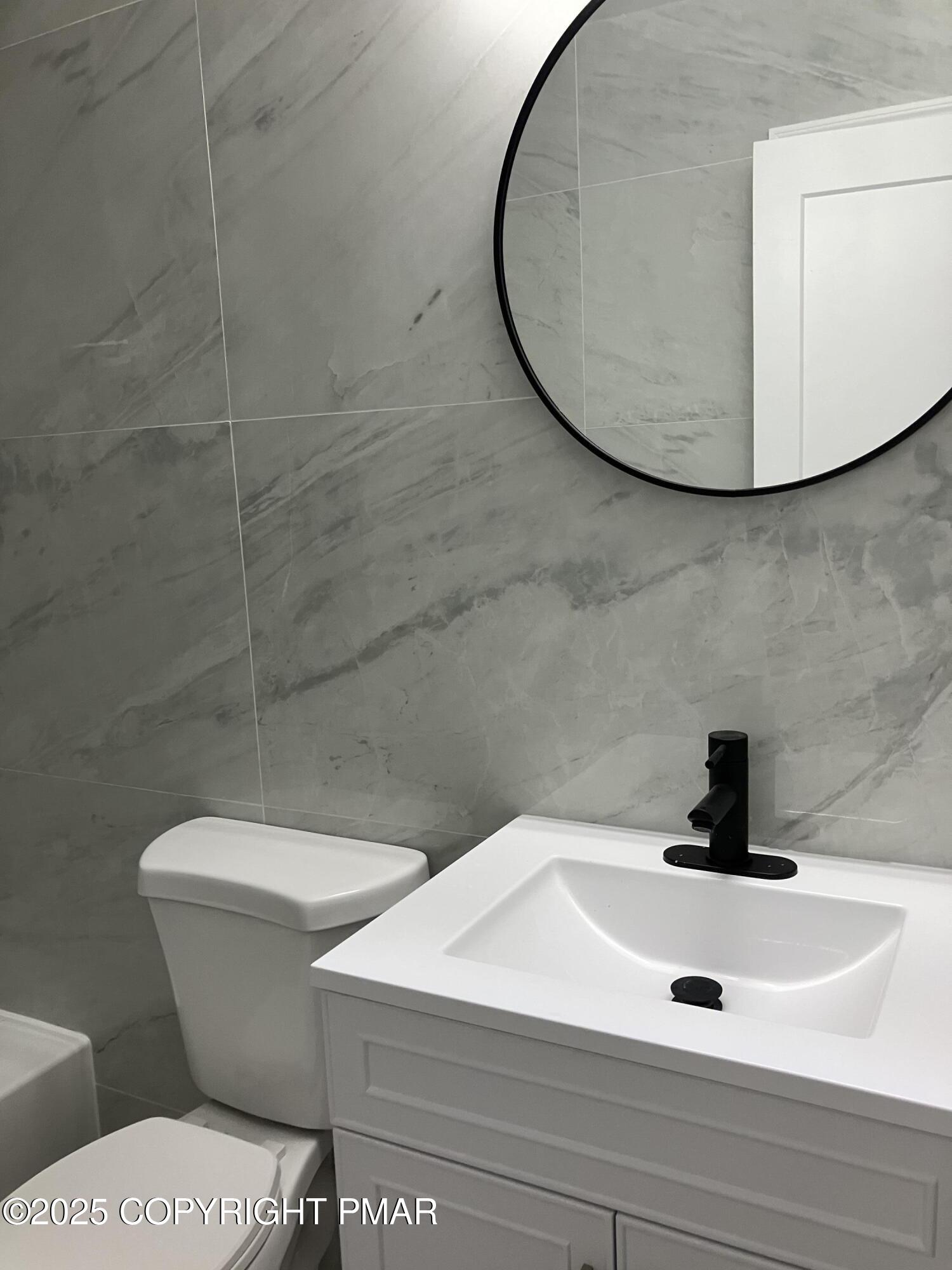 2096 Scarborough Way Bushkill, PA 18324 - Photo 12 of 38 a bathroom with a sink a toilet and mirror