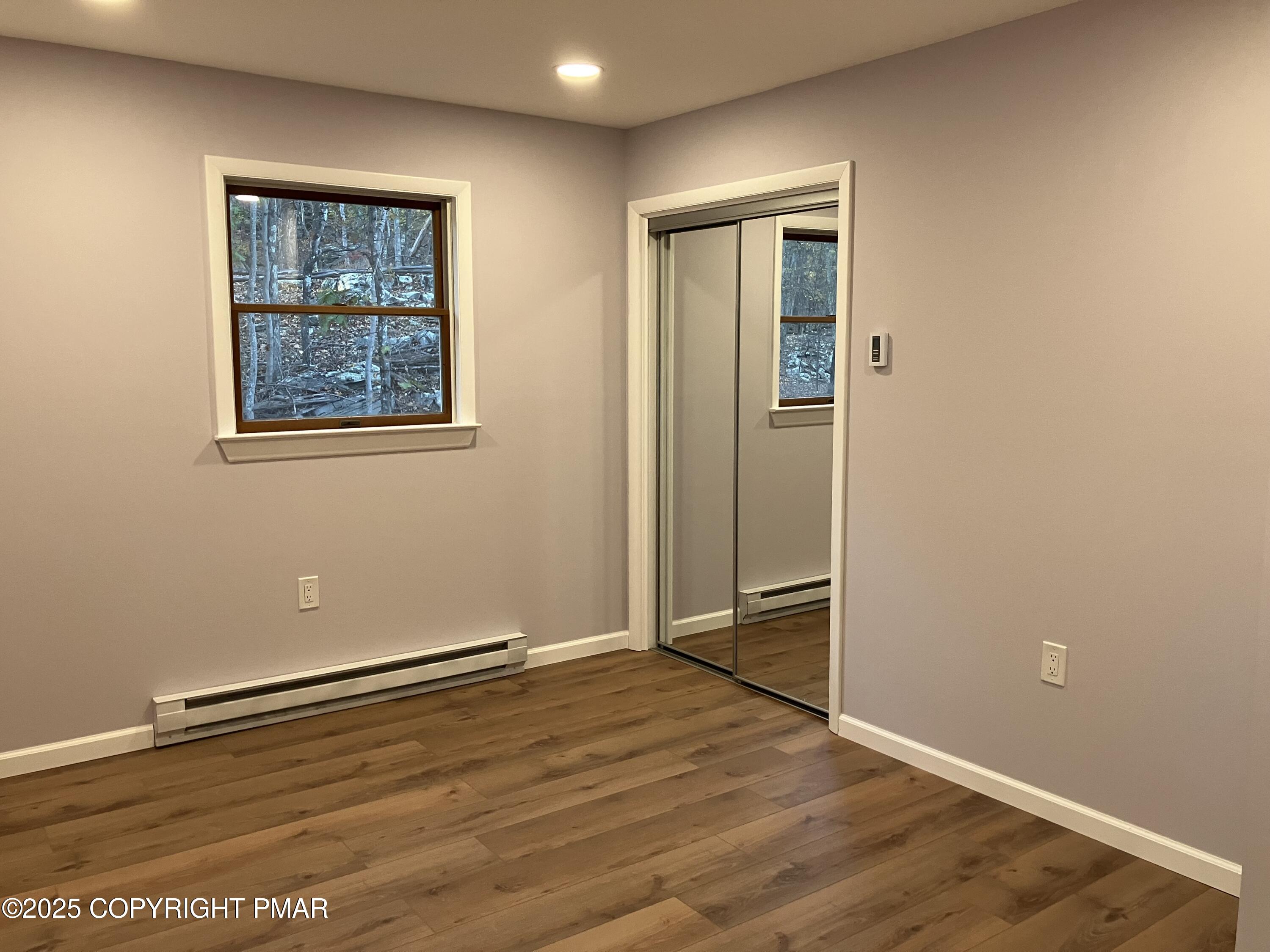 2096 Scarborough Way Bushkill, PA 18324 - Photo 15 of 38 an empty room with wooden floor closet and windows