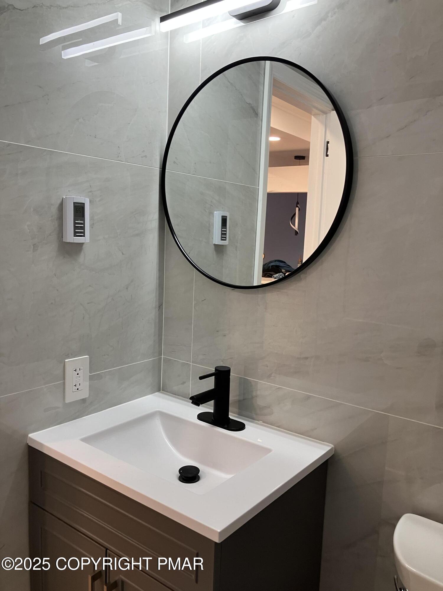 2096 Scarborough Way Bushkill, PA 18324 - Photo 27 of 38 a bathroom with a sink a mirror and vanity