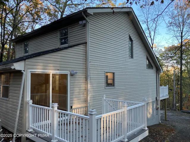 a view of a hallway with wooden floor and stairs