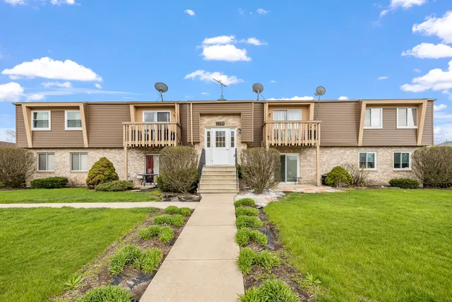 a front view of a house with a yard and porch