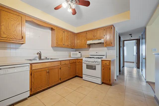 a kitchen with granite countertop a sink stainless steel appliances and cabinets