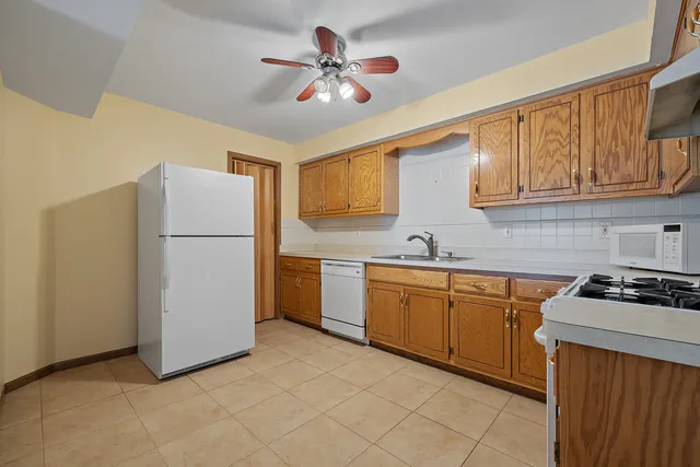 a kitchen with stainless steel appliances granite countertop a refrigerator sink and cabinets