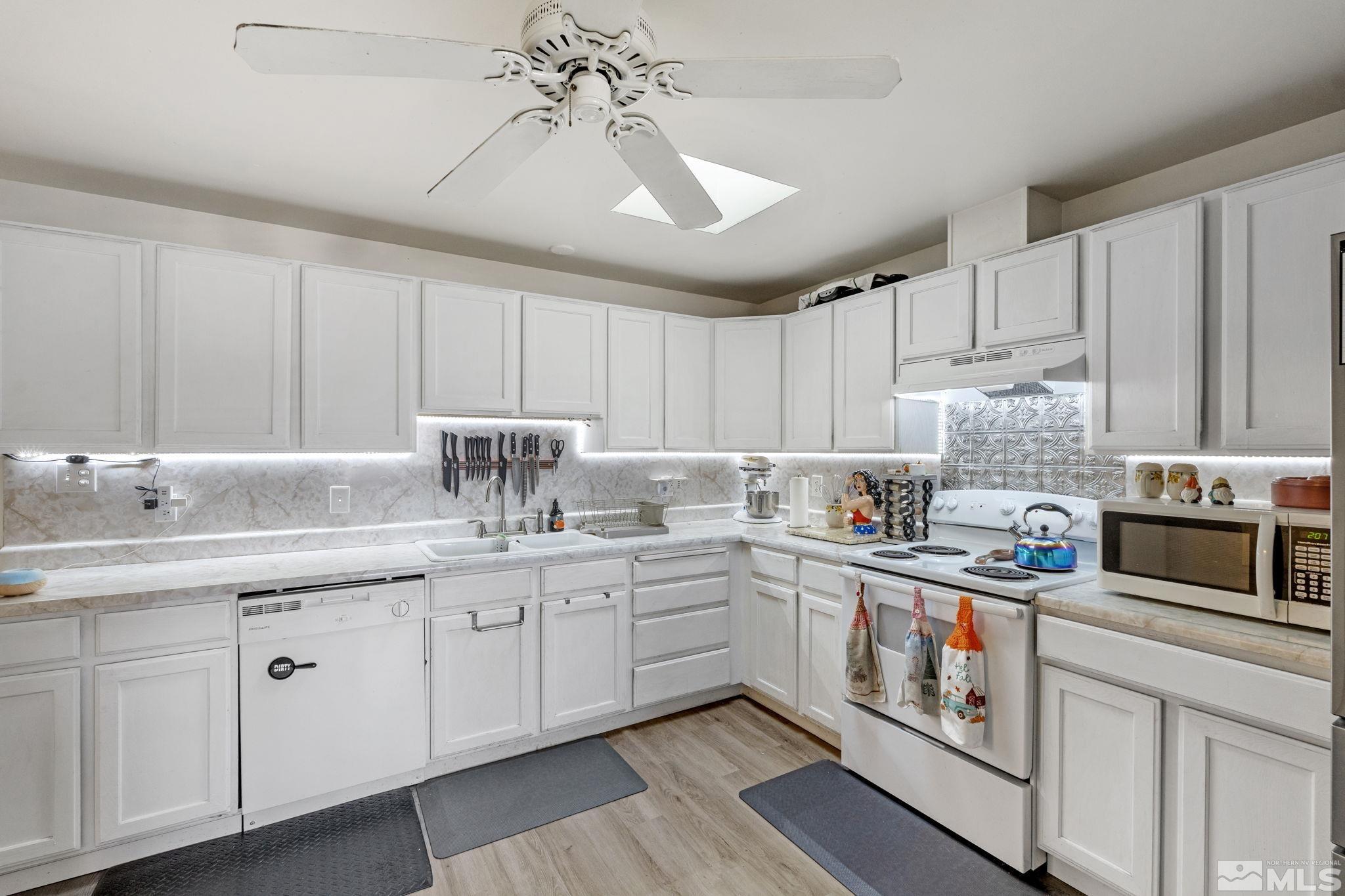1855 Desna Street Reno, NV 89512 - Photo 11 of 35 a kitchen with stainless steel appliances granite countertop a sink and cabinets