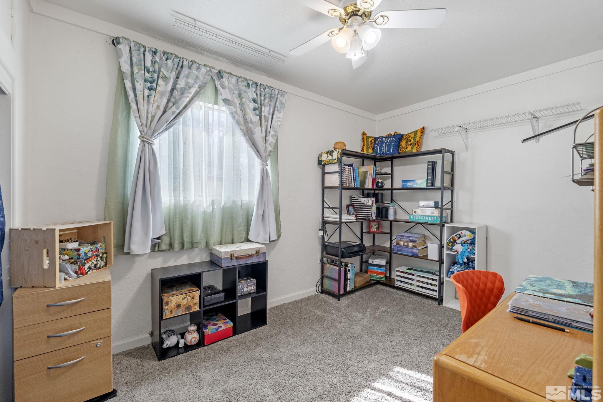 1855 Desna Street Reno, NV 89512 - Photo 14 of 35 a room with furniture and a book shelf